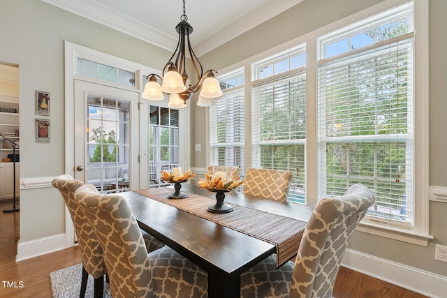 dining area featuring a wealth of natural light, crown molding, and dark hardwood / wood-style floors