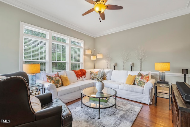 living room featuring ornamental molding, hardwood / wood-style flooring, and ceiling fan