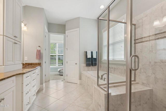 bathroom featuring vanity, plus walk in shower, and tile patterned floors