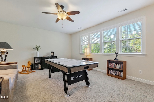 playroom with light carpet and ceiling fan