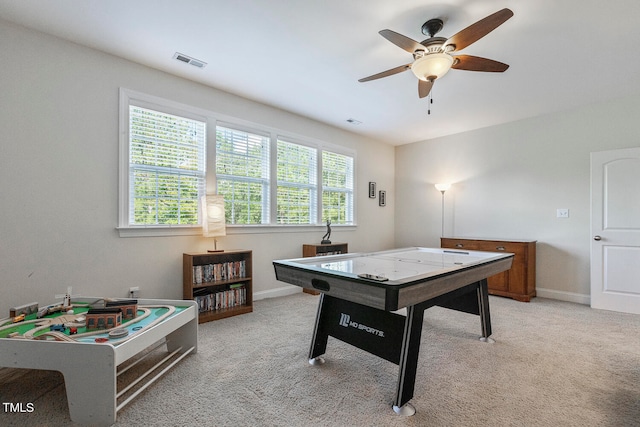 playroom with light carpet and ceiling fan