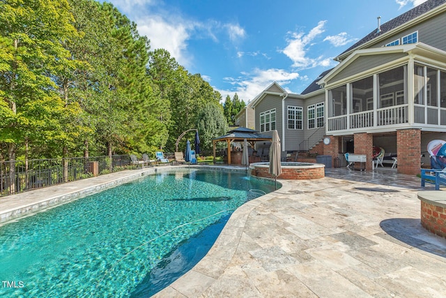 view of pool featuring a gazebo, a patio area, an in ground hot tub, and a sunroom