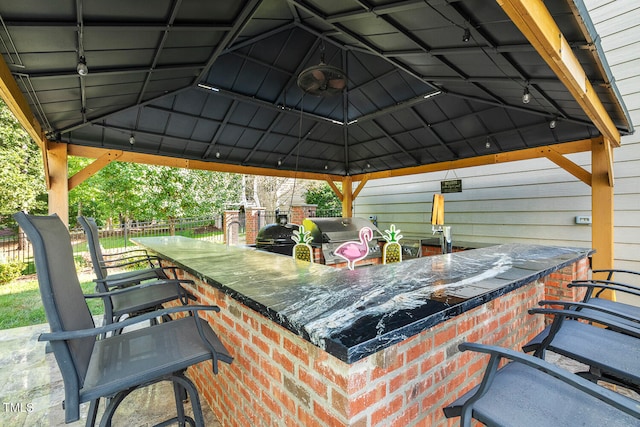 view of patio / terrace featuring a gazebo, an outdoor bar, and grilling area