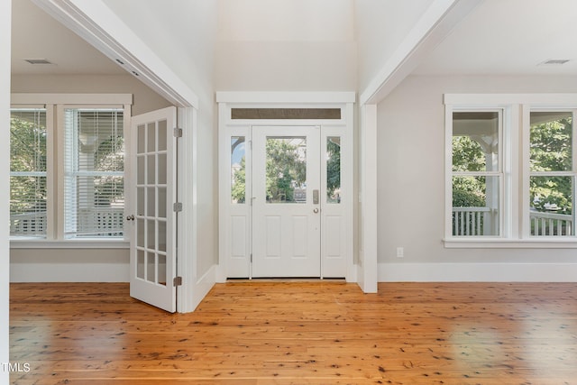 entryway with plenty of natural light and light hardwood / wood-style floors