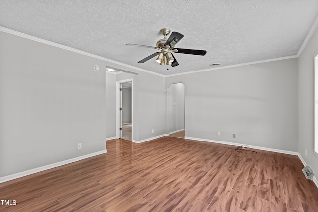 empty room featuring a textured ceiling, ornamental molding, hardwood / wood-style floors, and ceiling fan