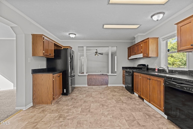 kitchen with a textured ceiling, sink, black appliances, ornamental molding, and ceiling fan