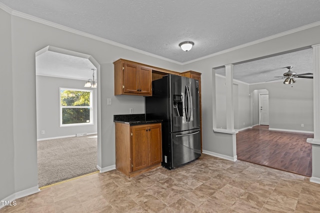 kitchen featuring a textured ceiling, stainless steel fridge with ice dispenser, light carpet, ceiling fan with notable chandelier, and crown molding