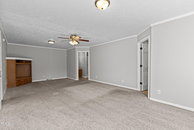 carpeted empty room with ceiling fan, crown molding, and a textured ceiling