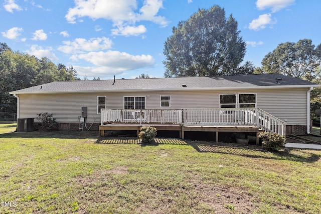 rear view of house with a lawn, a deck, and central air condition unit