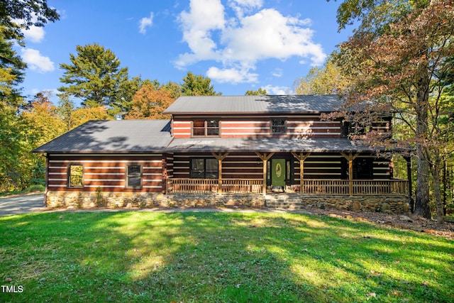 cabin with a porch and a front lawn