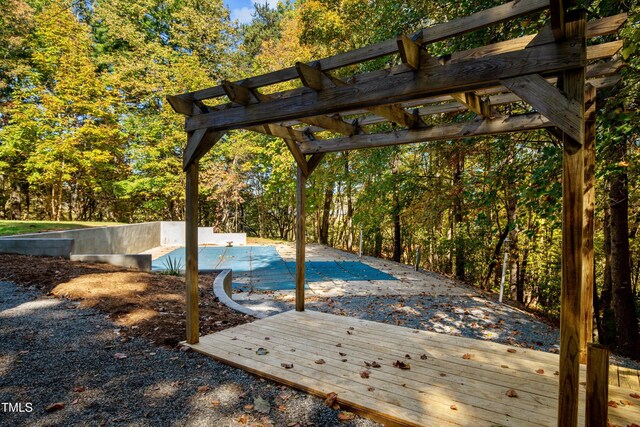 view of pool featuring a pergola and a wooden deck