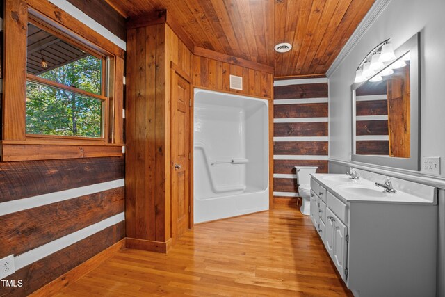 bathroom with wood-type flooring, toilet, wooden ceiling, wooden walls, and vanity