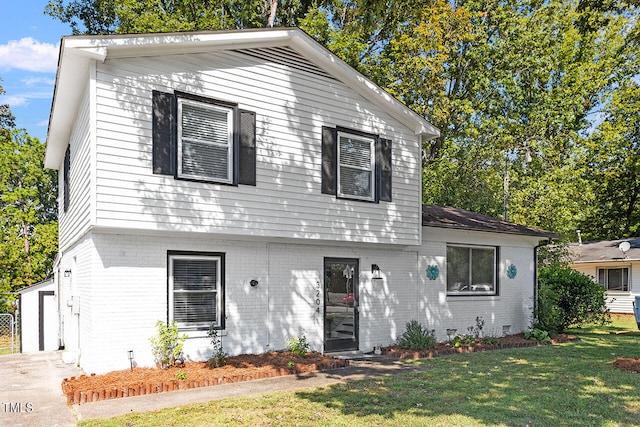 view of front of home with a garage and a front yard