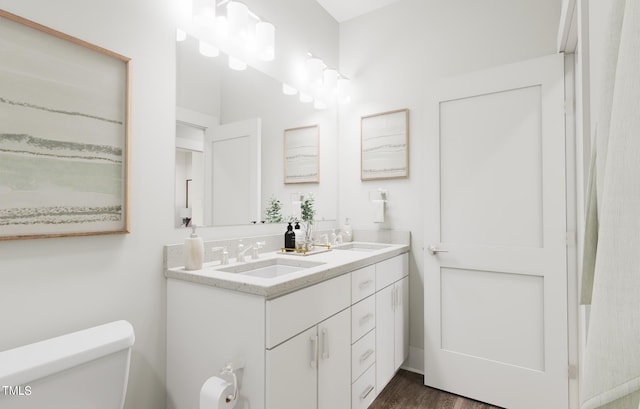 bathroom featuring hardwood / wood-style floors, vanity, and toilet