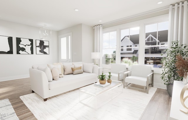 living room with hardwood / wood-style flooring, a wealth of natural light, and an inviting chandelier