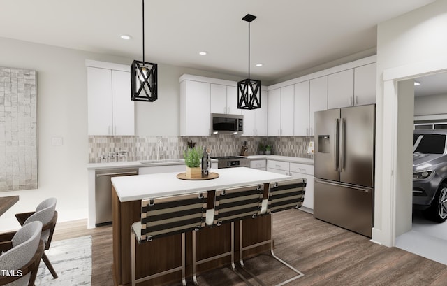 kitchen with tasteful backsplash, dark hardwood / wood-style flooring, pendant lighting, white cabinets, and appliances with stainless steel finishes