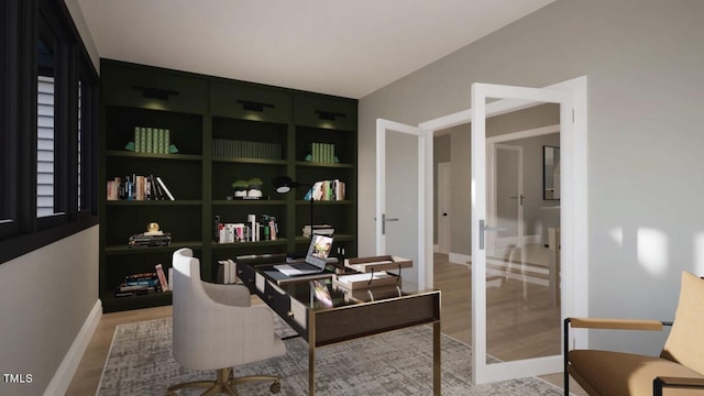 home office featuring built in shelves and hardwood / wood-style floors