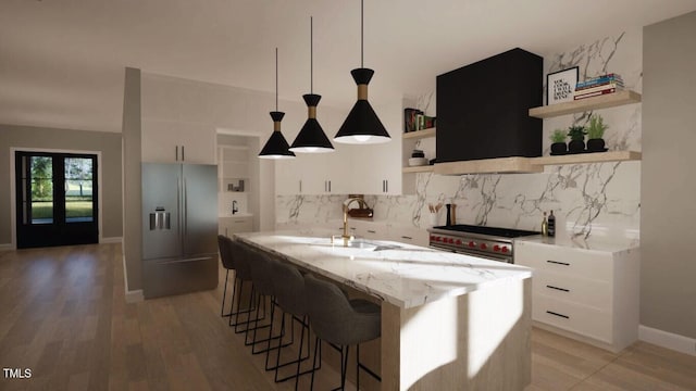 kitchen featuring backsplash, appliances with stainless steel finishes, and white cabinets