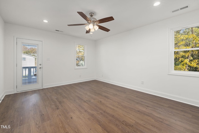 empty room with ceiling fan and dark hardwood / wood-style flooring