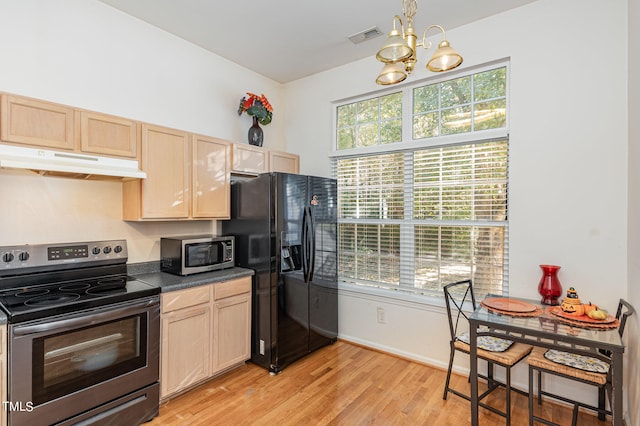 kitchen featuring appliances with stainless steel finishes, light brown cabinetry, a healthy amount of sunlight, and light hardwood / wood-style flooring