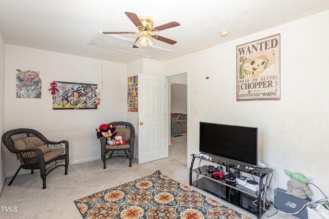 sitting room featuring light carpet and ceiling fan