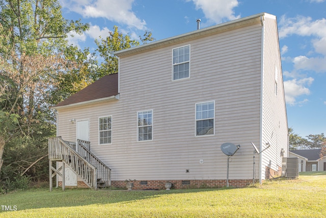 back of property featuring a lawn