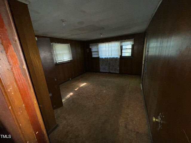 empty room featuring wooden walls