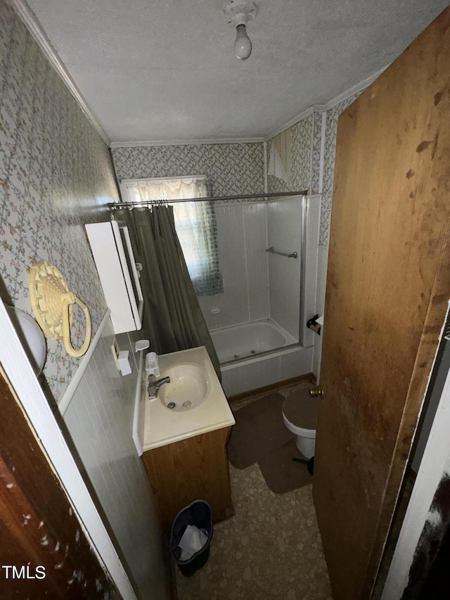 full bathroom with vanity, shower / bathtub combination with curtain, ornamental molding, toilet, and a textured ceiling