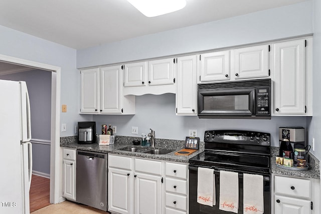 kitchen featuring black appliances, dark stone counters, white cabinetry, light wood-type flooring, and sink