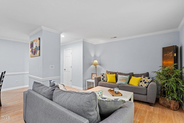 living room with light hardwood / wood-style floors and crown molding