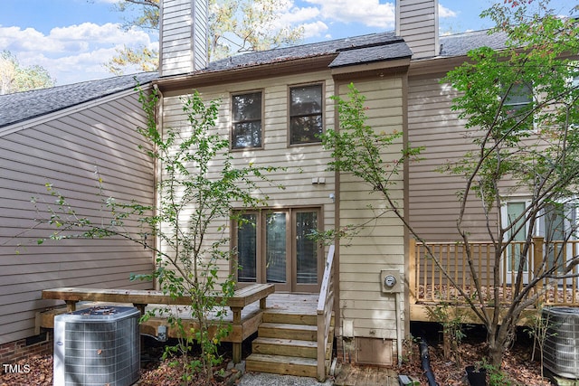 rear view of property featuring central AC unit and a deck