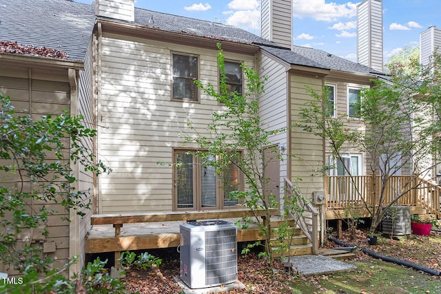 back of house featuring central AC and a wooden deck