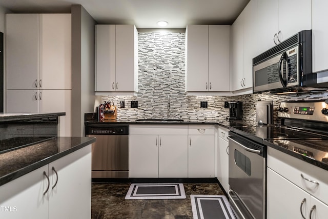 kitchen with white cabinets, appliances with stainless steel finishes, backsplash, and sink