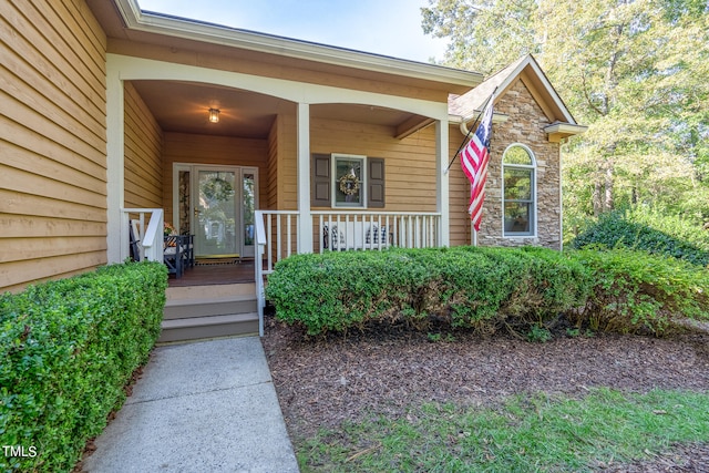 view of exterior entry with a porch