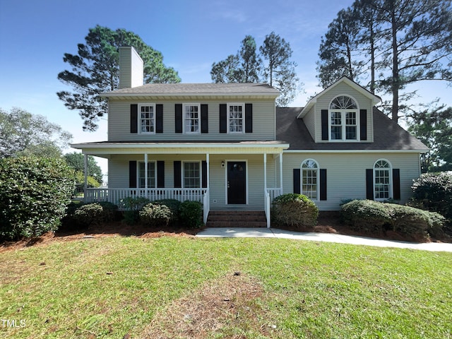 view of front of property with a front yard and covered porch