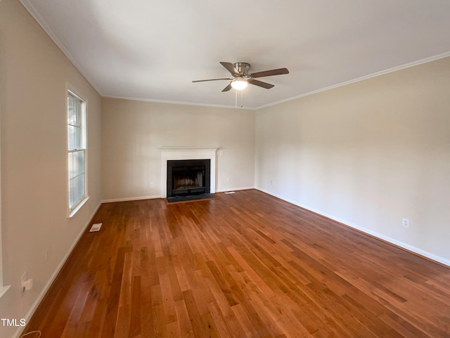 unfurnished living room with wood-type flooring, crown molding, and ceiling fan