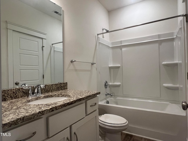 full bathroom with bathing tub / shower combination, hardwood / wood-style flooring, vanity, and toilet