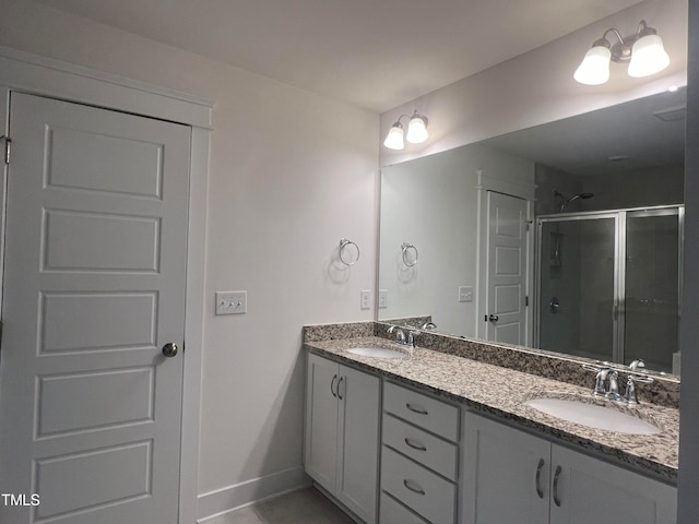 bathroom featuring walk in shower and vanity