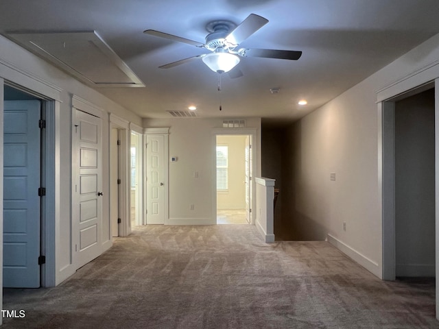 spare room featuring ceiling fan and carpet