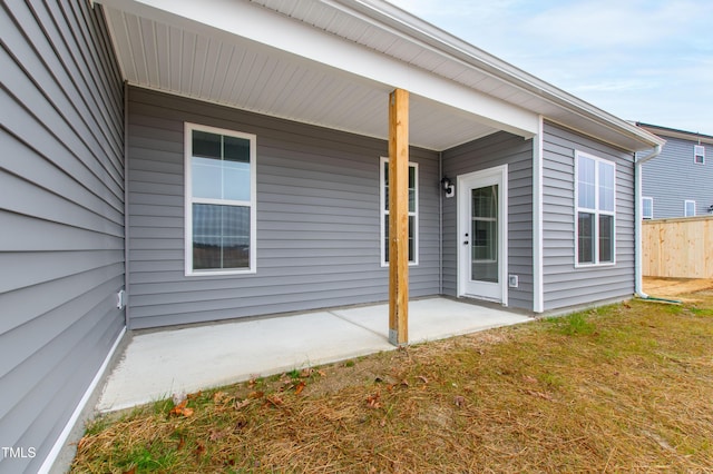 property entrance with a lawn