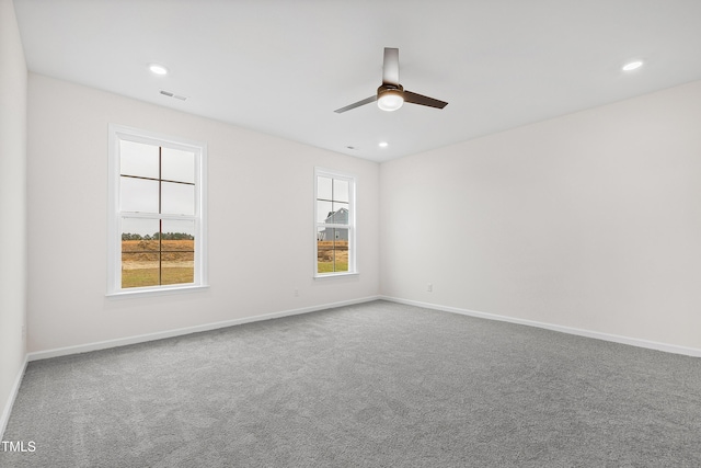 empty room featuring ceiling fan and carpet floors