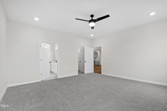 unfurnished bedroom with carpet floors, ensuite bath, and ceiling fan