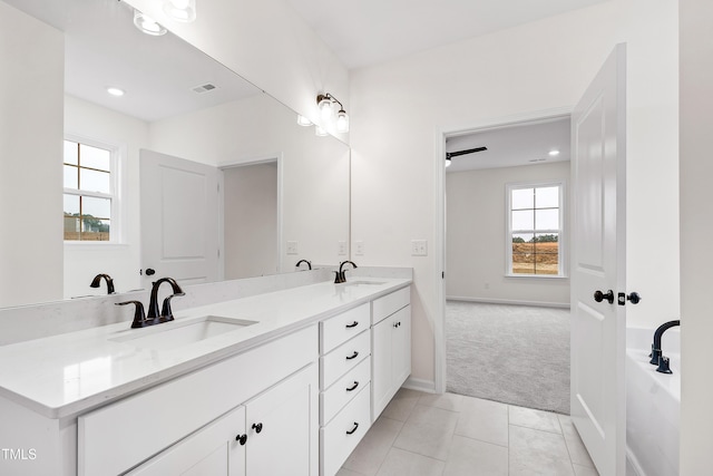 bathroom with tile patterned floors and vanity