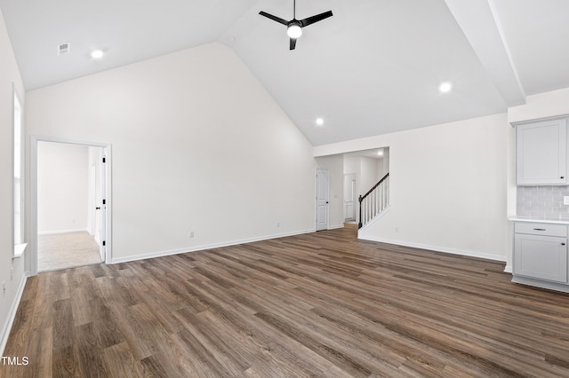 unfurnished living room featuring ceiling fan, high vaulted ceiling, and dark hardwood / wood-style floors