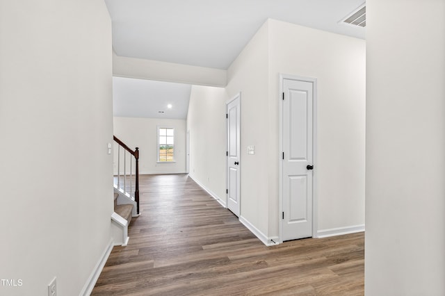 hall with hardwood / wood-style flooring