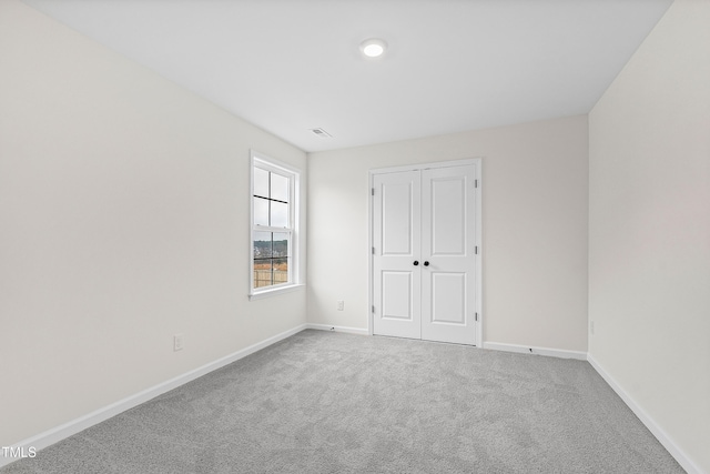 unfurnished bedroom with carpet floors and a closet