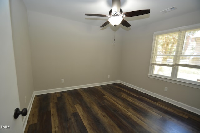 unfurnished room with ceiling fan, dark wood-type flooring, and a healthy amount of sunlight