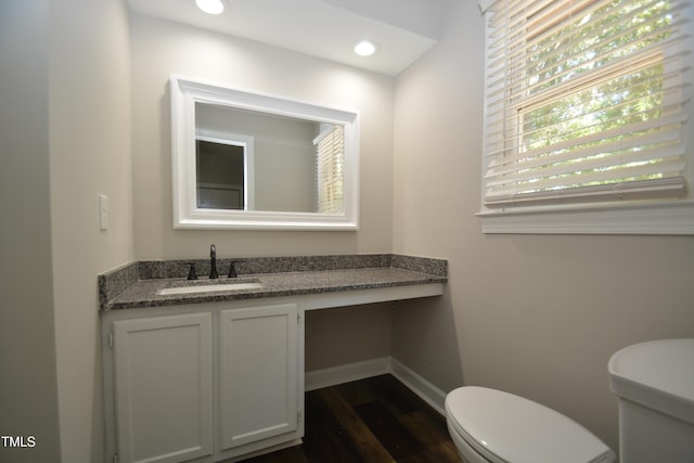 bathroom featuring vanity, hardwood / wood-style floors, and toilet