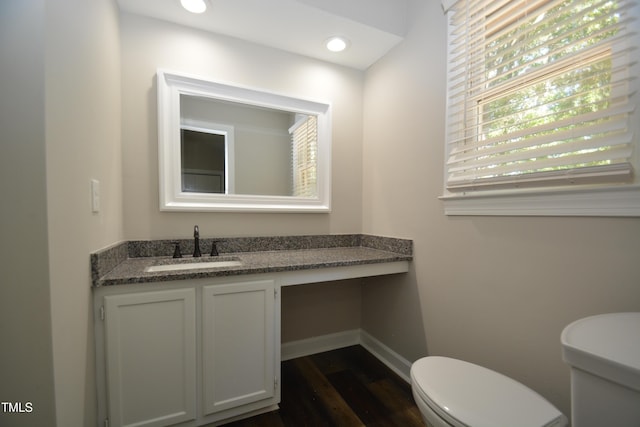 500 W Woodcroft Pkwy Unit 8C, Durham, NC 27713 - half bath featuring wood finished floors, vanity, toilet, and baseboards