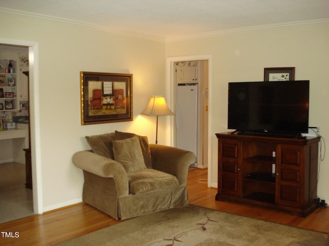 living room with hardwood / wood-style flooring and crown molding